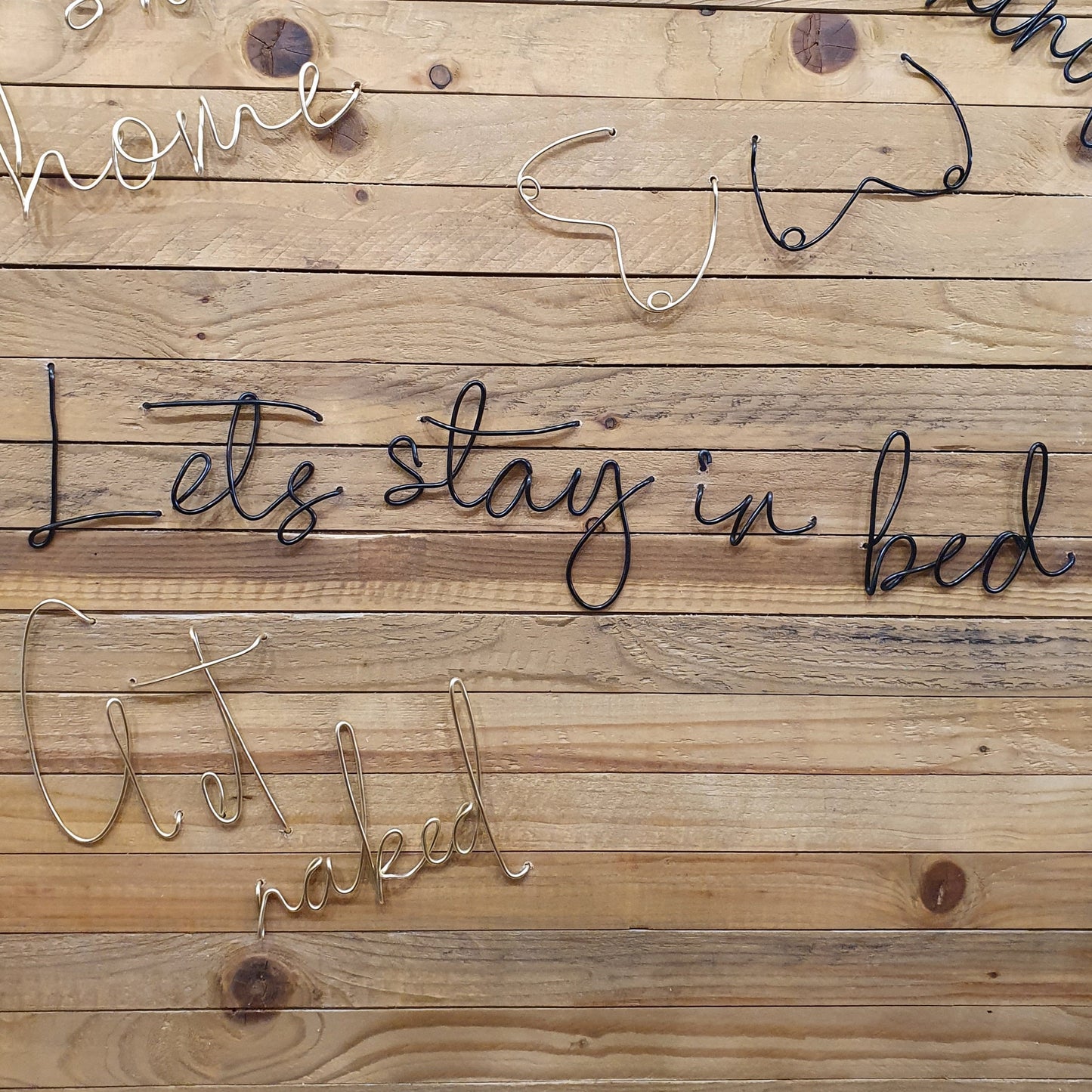Black Lets Stay In Bed Wire Word Wall Art for hanging onto the wall. Wood Panel background.