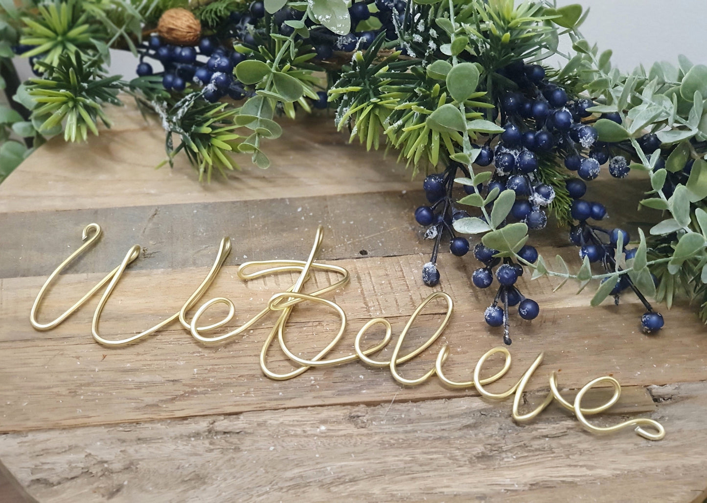 Gold We Believe Wire Word Mantle or Table Decoration Framed with a Festive frosted Berry Garland