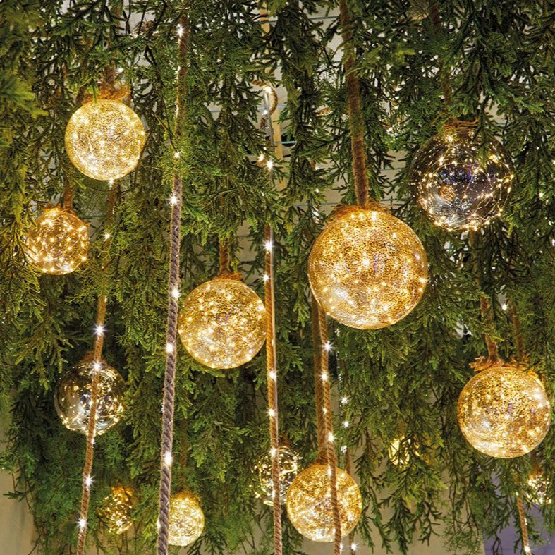 Beautiful festive display of hanging LED battery operated Christmas Bauble on Jute rope